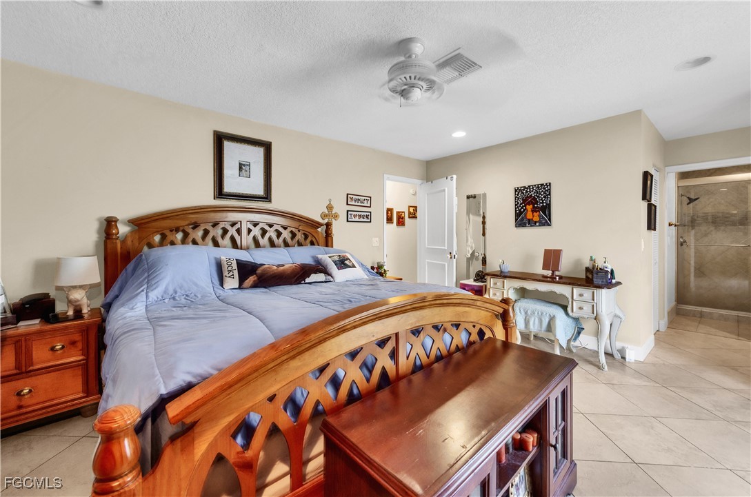 9141 Southwest 22nd Street, Unit F Boca Raton, FL 33428 - Photo 18 of 30 a bedroom with a bed and a table in it