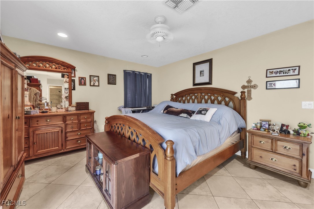 9141 Southwest 22nd Street, Unit F Boca Raton, FL 33428 - Photo 19 of 30 a bedroom with a bed and dresser