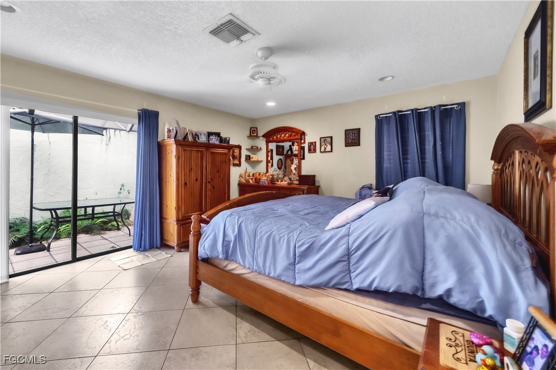 9141 Southwest 22nd Street, Unit F Boca Raton, FL 33428 - Photo 20 of 30 a bed sitting in a spacious bedroom next to a window