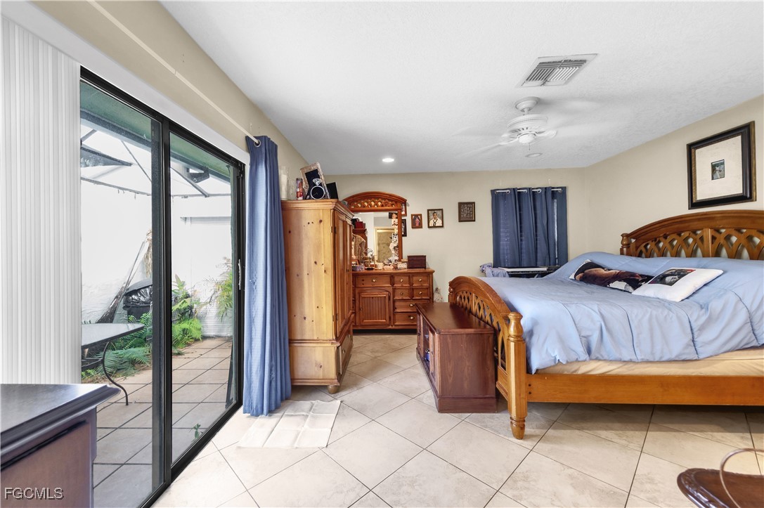 9141 Southwest 22nd Street, Unit F Boca Raton, FL 33428 - Photo 21 of 30 a bedroom with a large bed and a large window