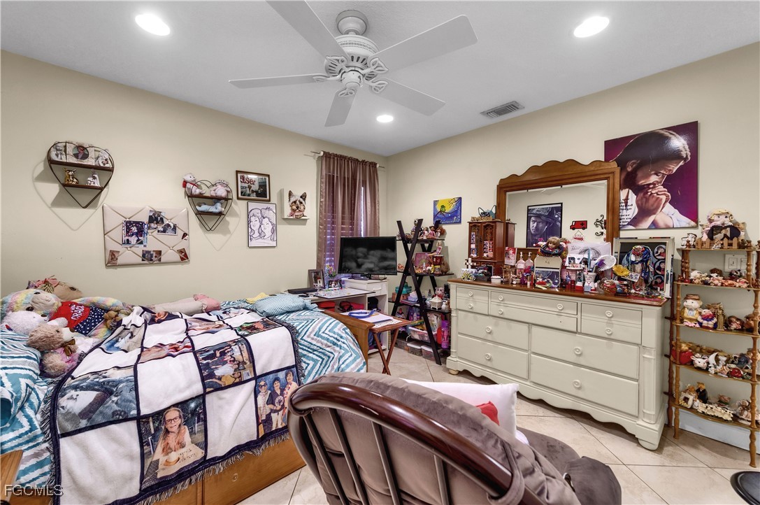 9141 Southwest 22nd Street, Unit F Boca Raton, FL 33428 - Photo 24 of 30 a bedroom with furniture and a chandelier