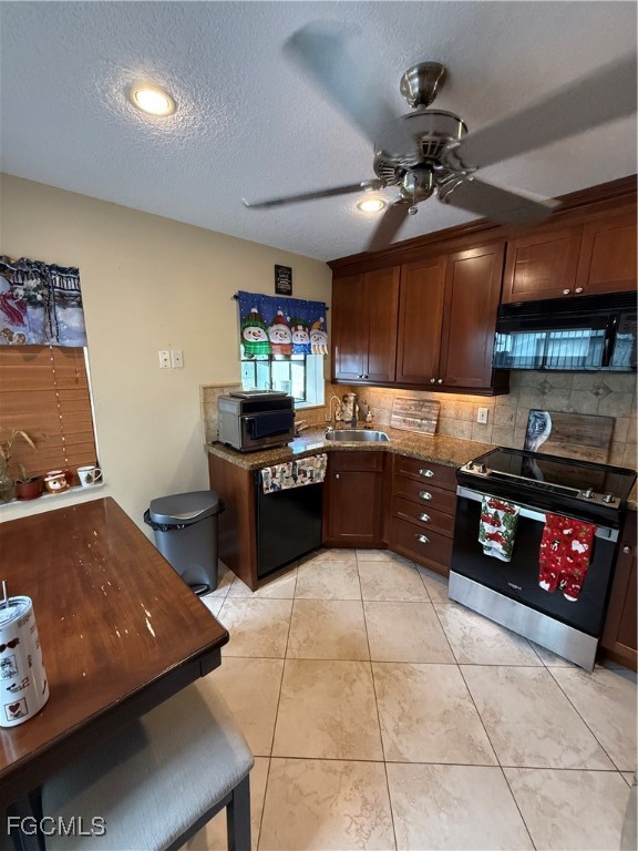 9141 Southwest 22nd Street Boca Raton, FL 33428 - Photo 4 of 14 a kitchen with stainless steel appliances granite countertop a sink counter space cabinets and a stove