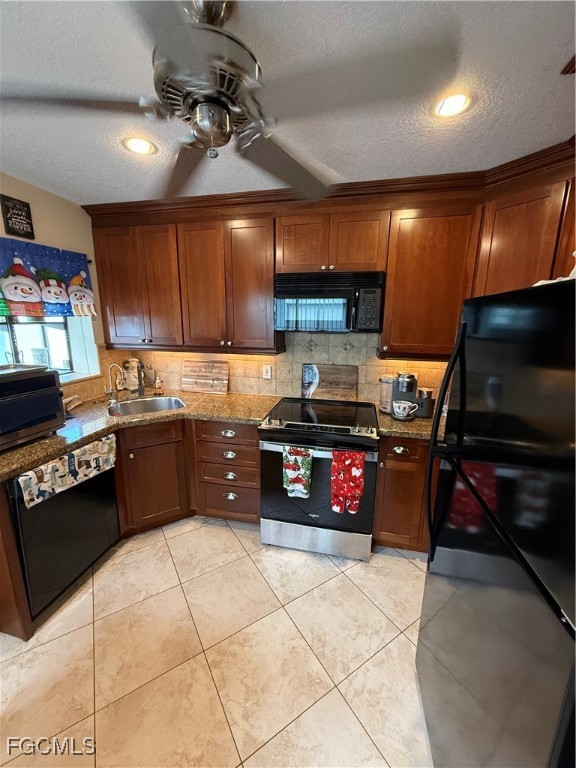 9141 Southwest 22nd Street Boca Raton, FL 33428 - Photo 6 of 14 a kitchen with stainless steel appliances granite countertop a stove sink and cabinets