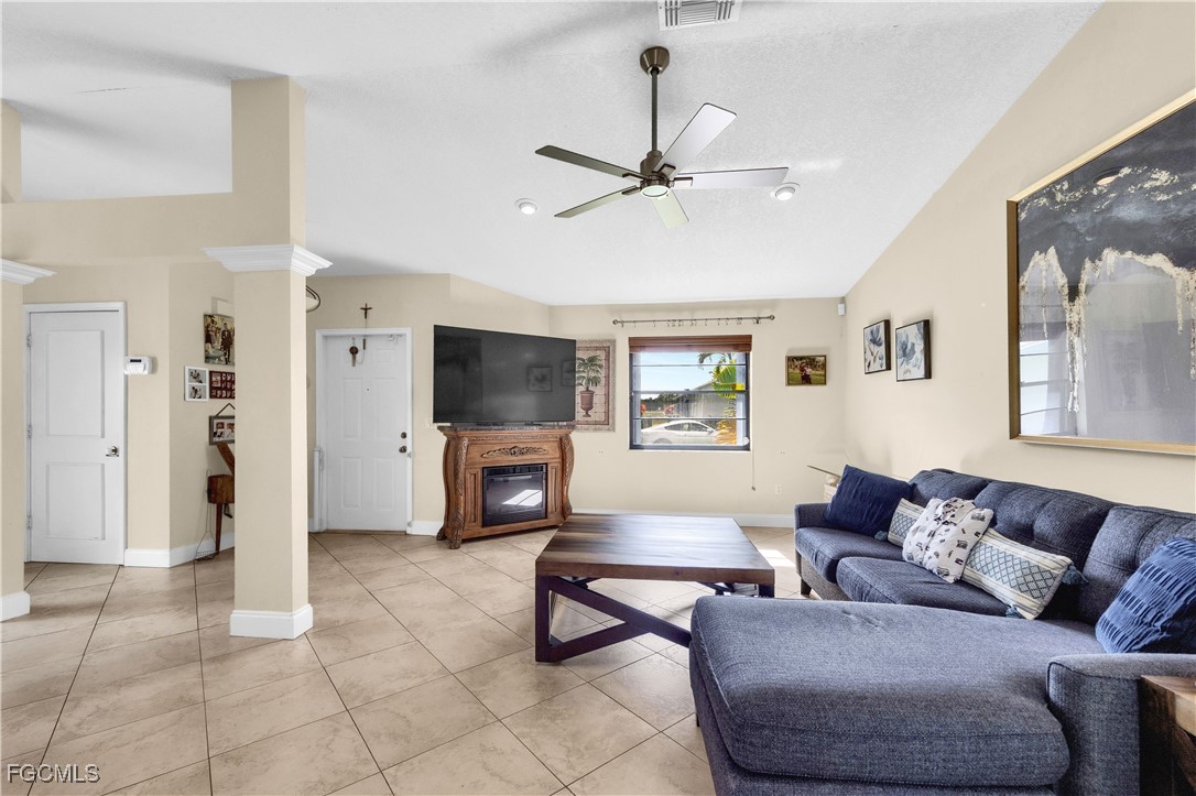 9141 Southwest 22nd Street, Unit F Boca Raton, FL 33428 - Photo 8 of 30 a living room with furniture a ceiling fan and a window