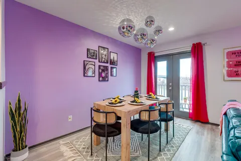 a dining room with furniture and wooden floor