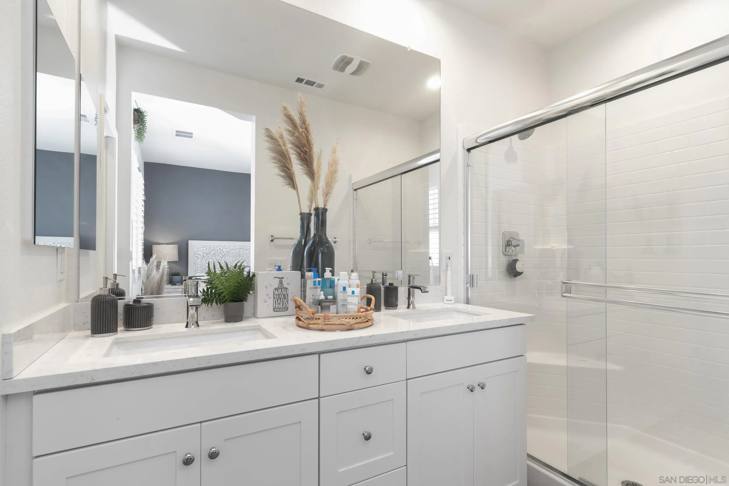 1380 Santa Victoria Road, Unit 2 Chula Vista, CA 91913 - Photo 15 of 27 a bathroom with double vanity sink and a mirror