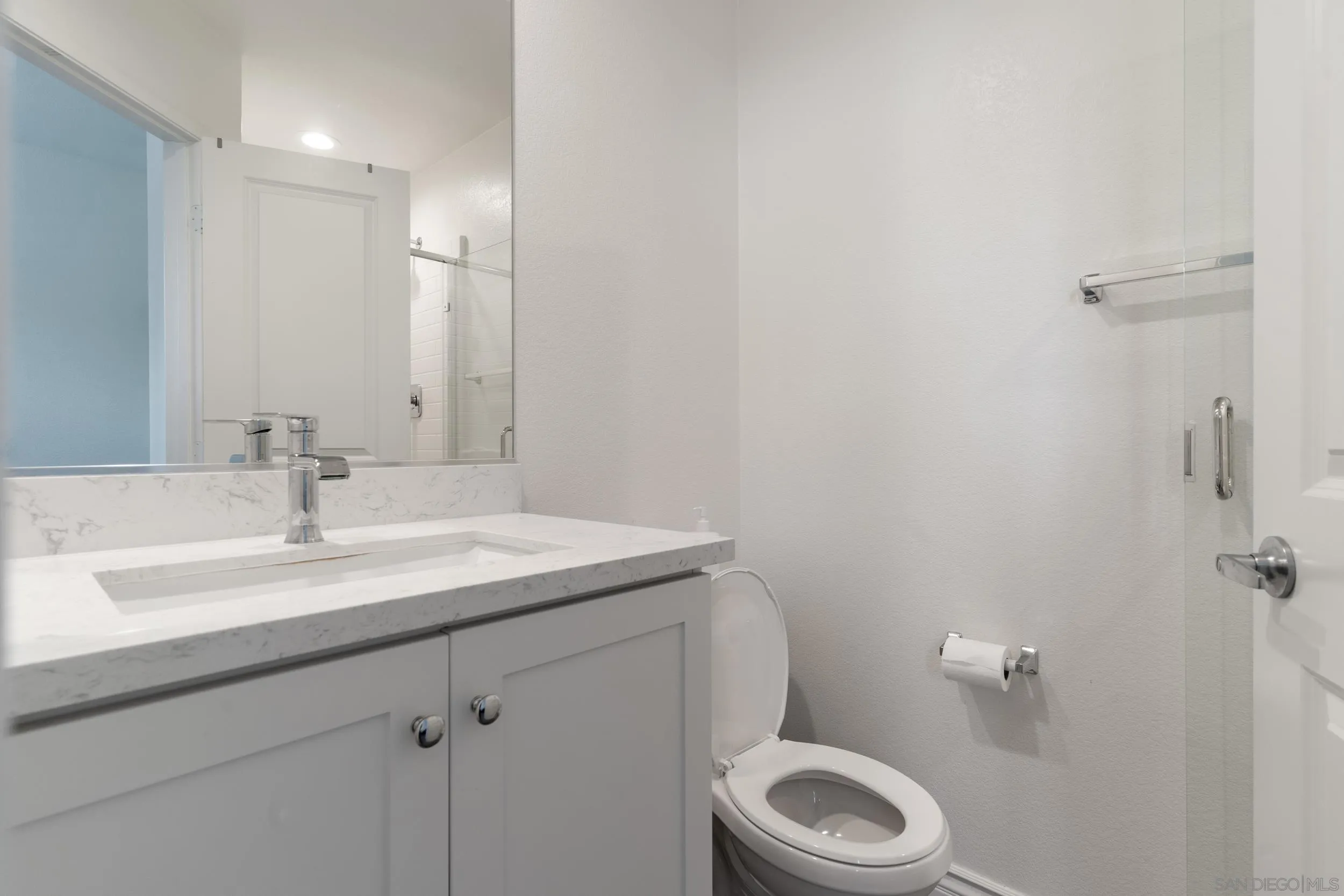 1380 Santa Victoria Road, Unit 2 Chula Vista, CA 91913 - Photo 4 of 27 a bathroom with a granite countertop toilet sink and mirror