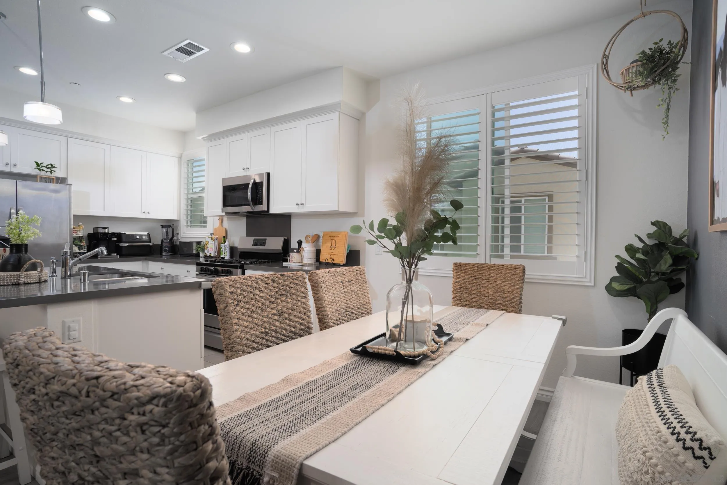1380 Santa Victoria Road, Unit 2 Chula Vista, CA 91913 - Photo 6 of 27 a kitchen with a table chairs stove and microwave