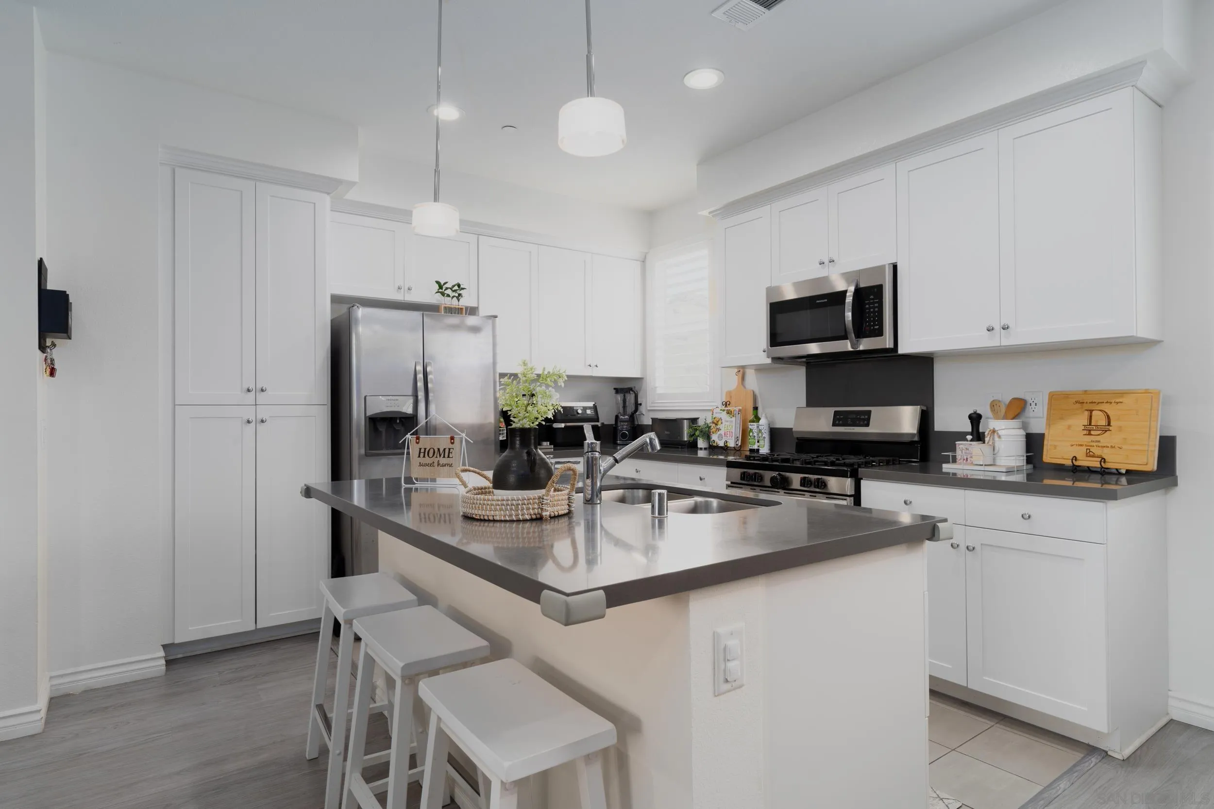 1380 Santa Victoria Road, Unit 2 Chula Vista, CA 91913 - Photo 9 of 27 a kitchen with stainless steel appliances granite countertop a sink a stove a refrigerator cabinets and a dining table