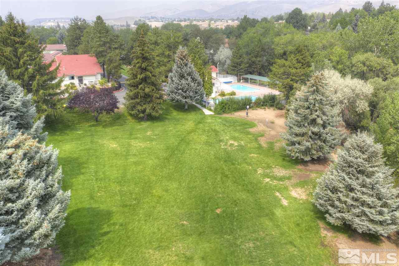 1221 Laredo Court Reno, NV 89503 - Photo 32 of 32 a view of a lake with a yard and a large trees