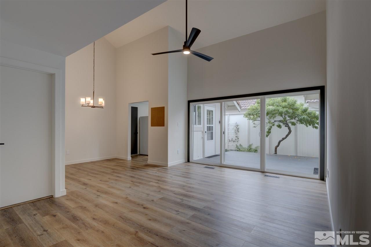 1221 Laredo Court Reno, NV 89503 - Photo 4 of 32 a view of an empty room with wooden floor and a window
