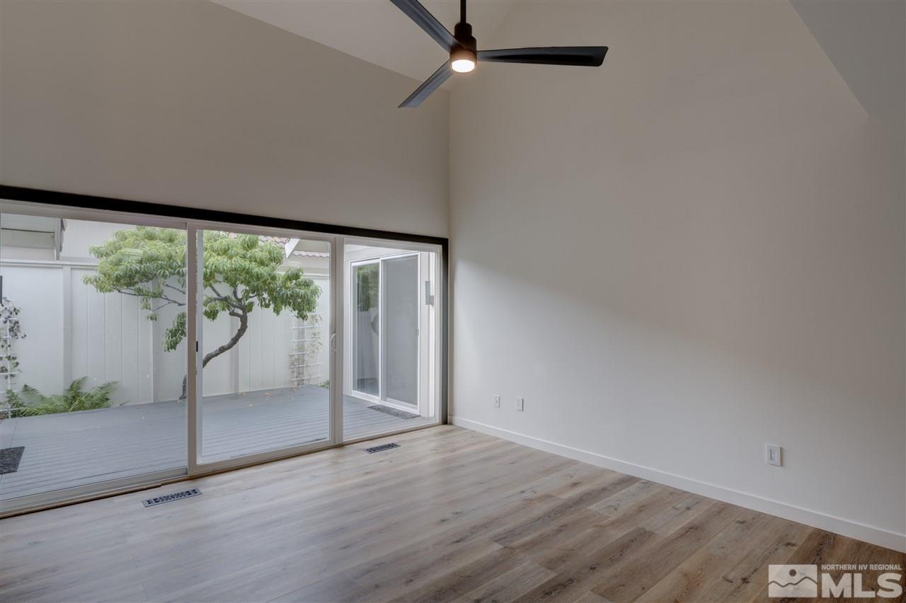 1221 Laredo Court Reno, NV 89503 - Photo 5 of 32 an empty room with wooden floor and windows