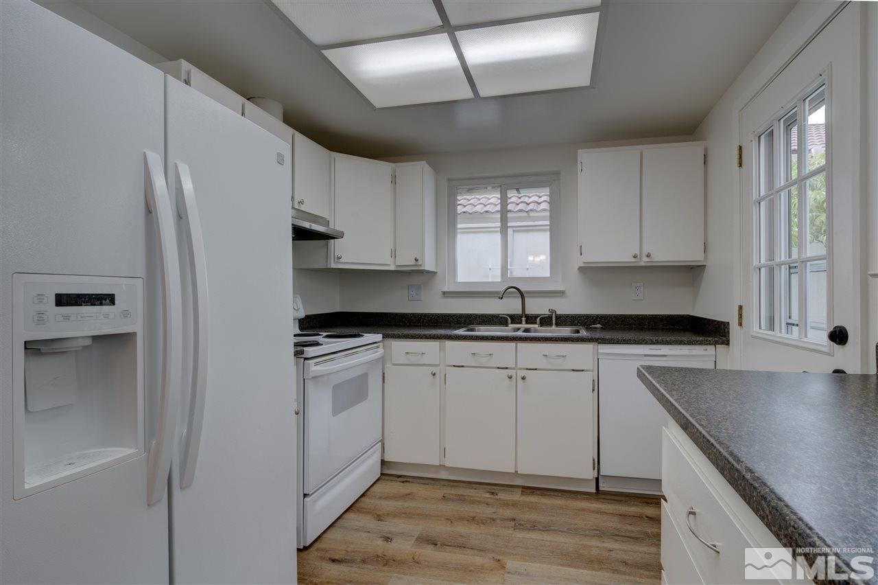 1221 Laredo Court Reno, NV 89503 - Photo 10 of 32 a kitchen with a sink stove and cabinets