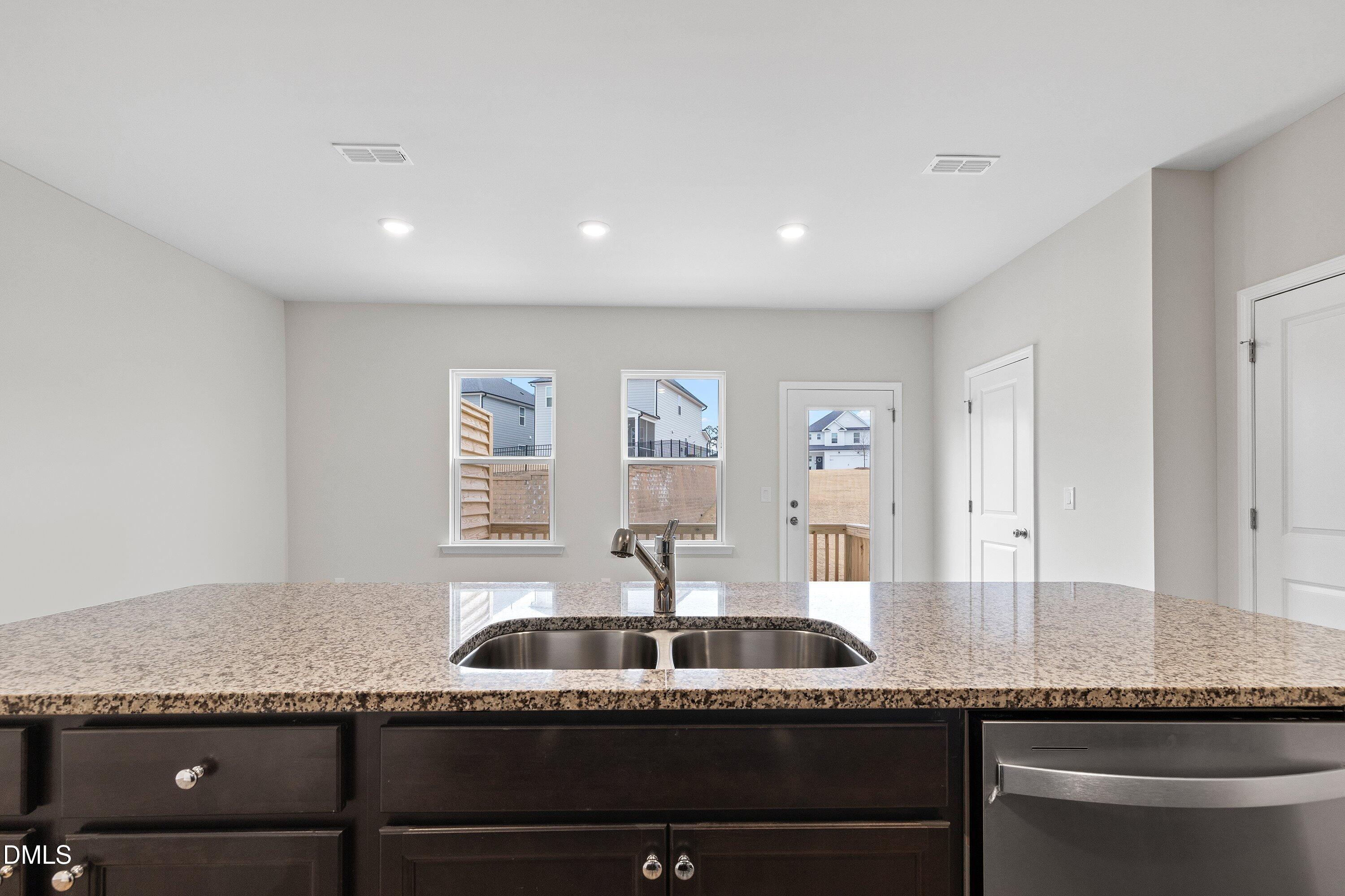 2550 Olive Chapel Road Apex, NC 27502 - Photo 12 of 41 a kitchen with granite countertop stainless steel appliances a sink and a counter space