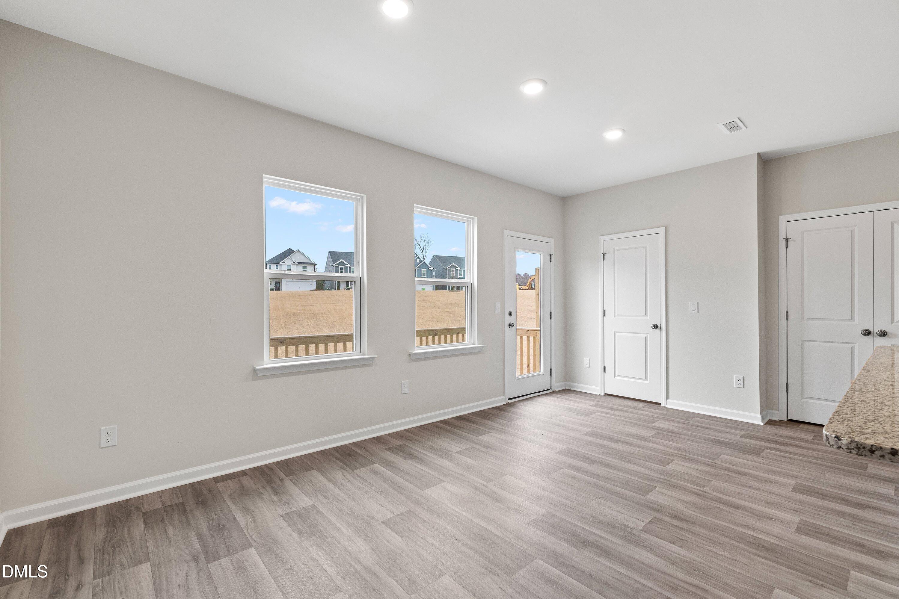 2550 Olive Chapel Road Apex, NC 27502 - Photo 16 of 41 a view of an empty room with wooden floor and a window