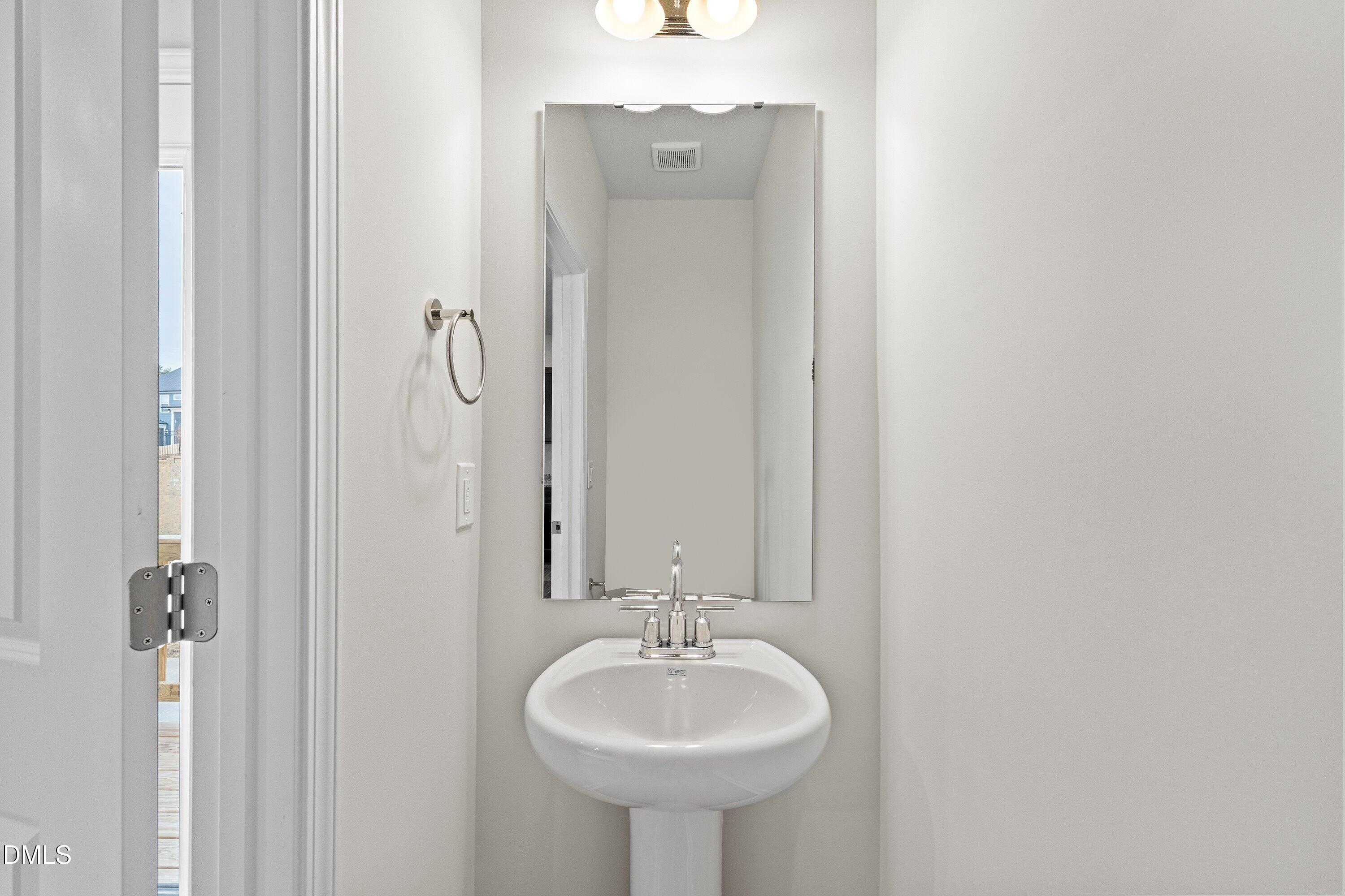 2550 Olive Chapel Road Apex, NC 27502 - Photo 17 of 41 a bathroom with a sink and a mirror