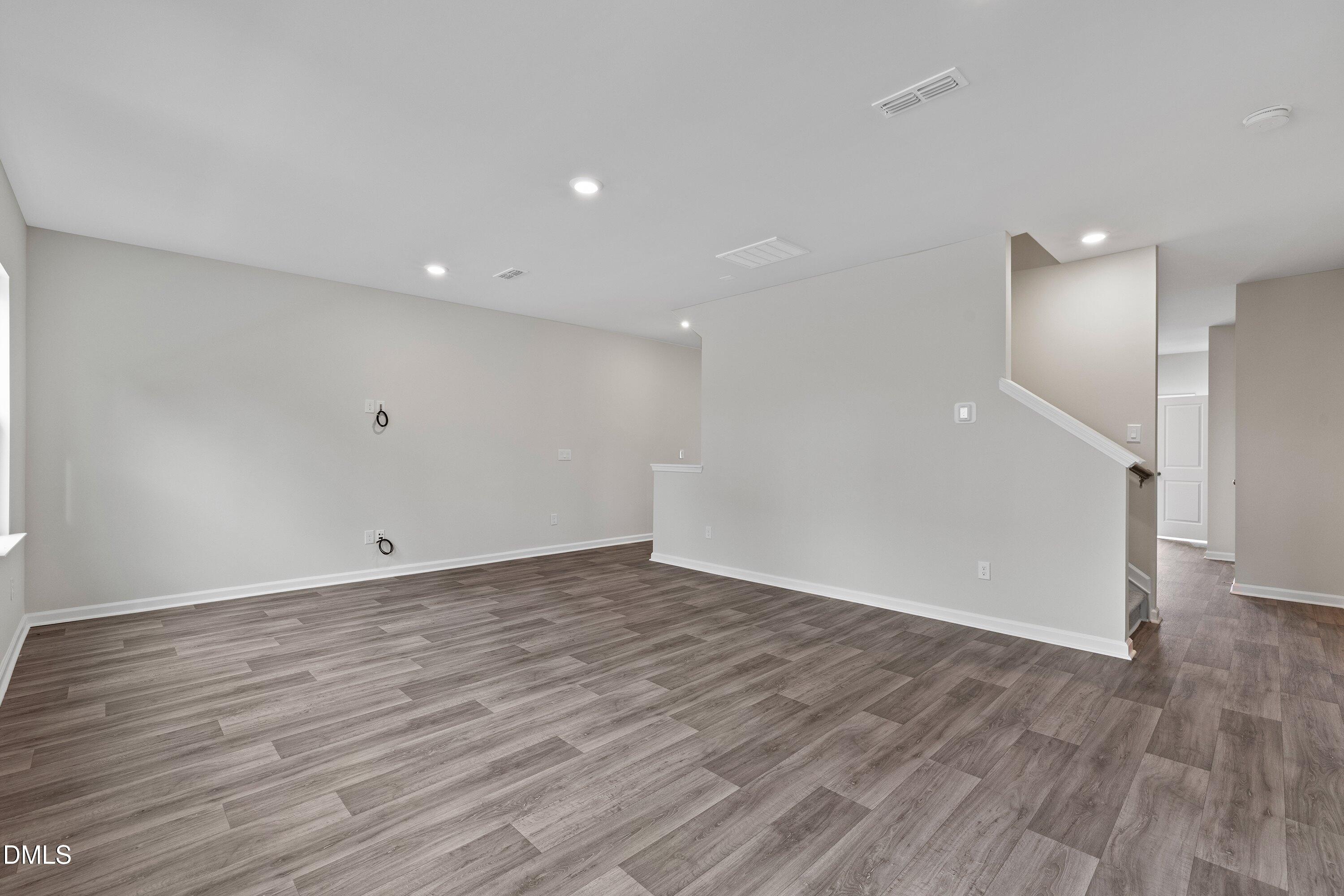 2550 Olive Chapel Road Apex, NC 27502 - Photo 21 of 41 a view of an empty room with wooden floor