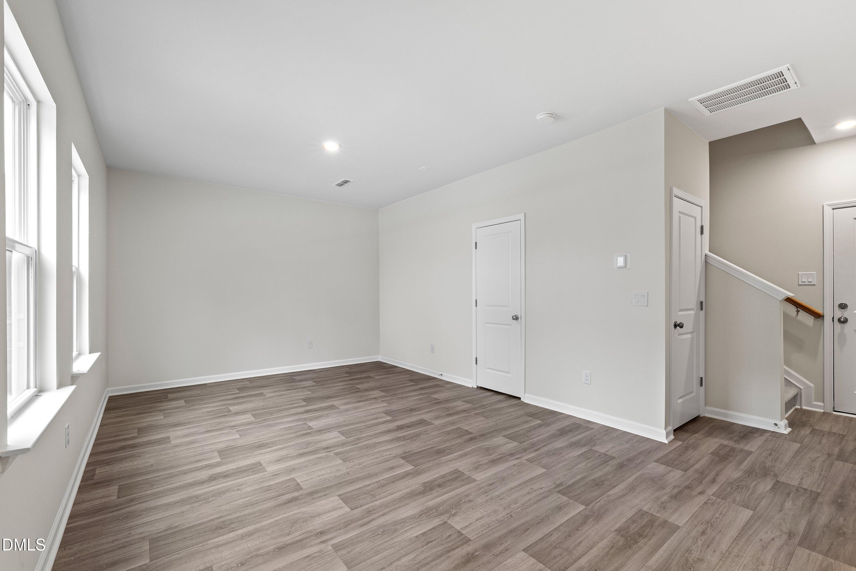 2550 Olive Chapel Road Apex, NC 27502 - Photo 4 of 41 a view of an empty room with wooden floor and a window