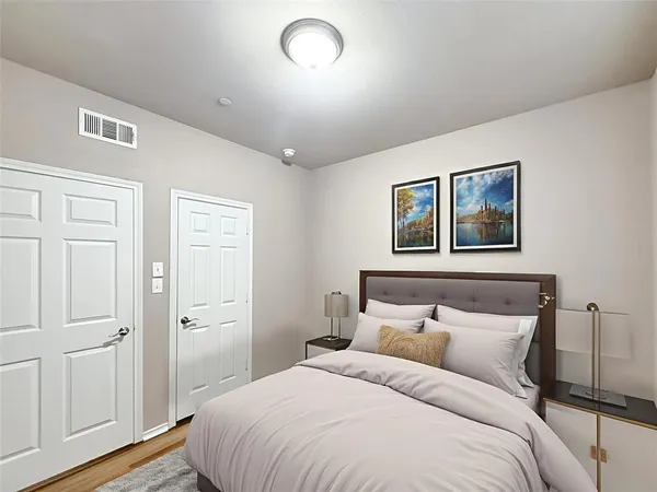 a bedroom with a bed and a painting on the wall