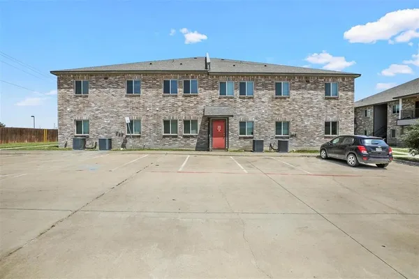 a view of building with car parked