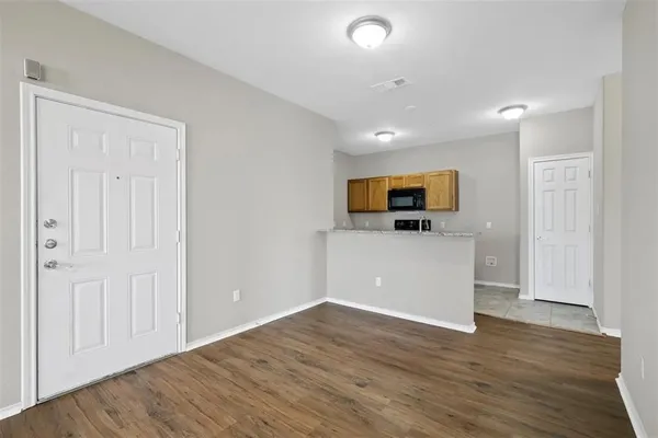 a view of a room with wooden floor and cabinet