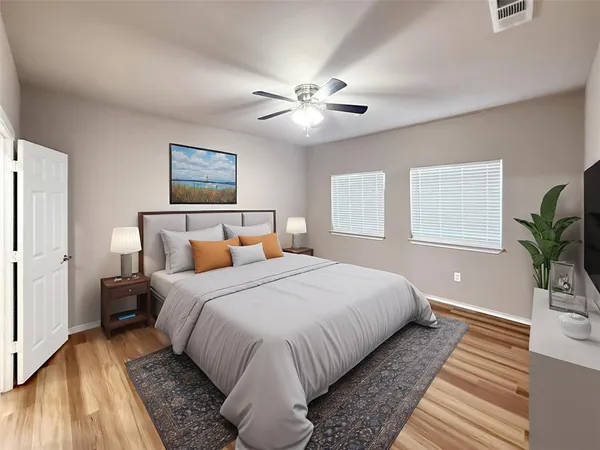 a bedroom with bed and a potted plant