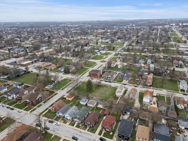 an aerial view of residential houses with city view