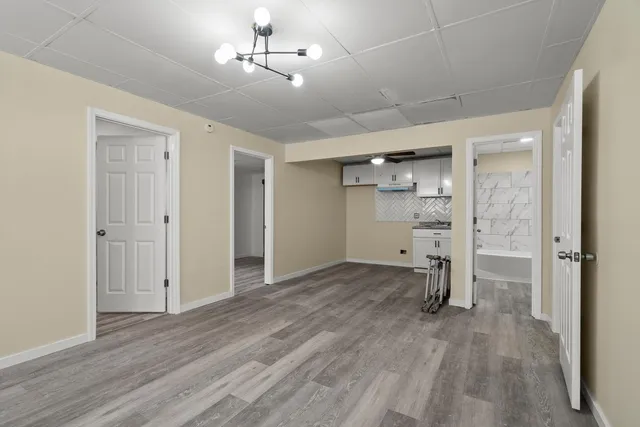 a view of empty room with wooden floor