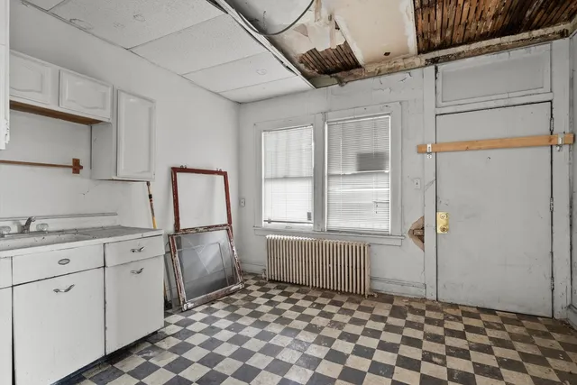 a view of storage and utility room with wooden floor