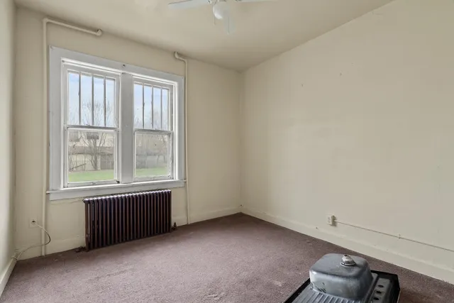 a room that has a chair and white walls