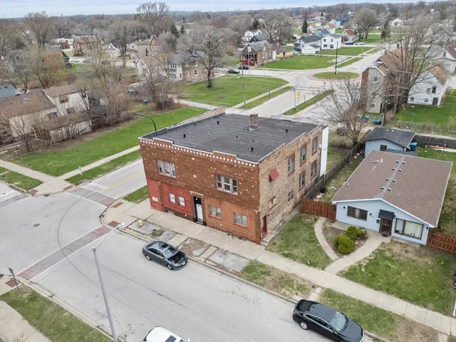 an aerial view of a house with a yard