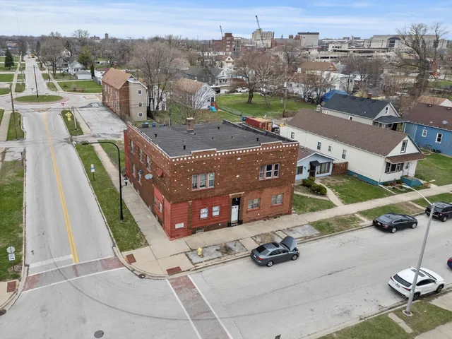 an aerial view of a house with a garden and mountain view