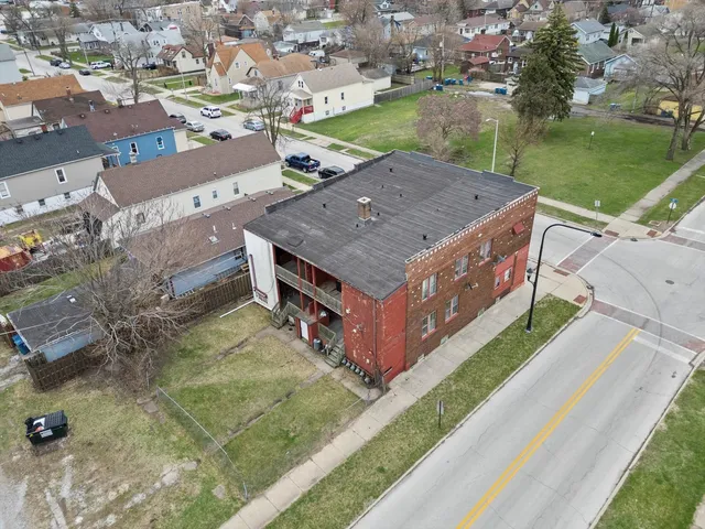 an aerial view of a house with a yard