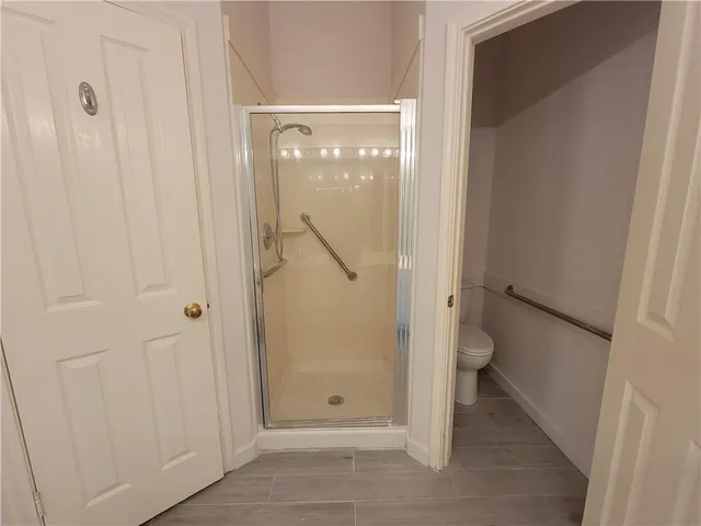 a bathroom that has a glass shower door