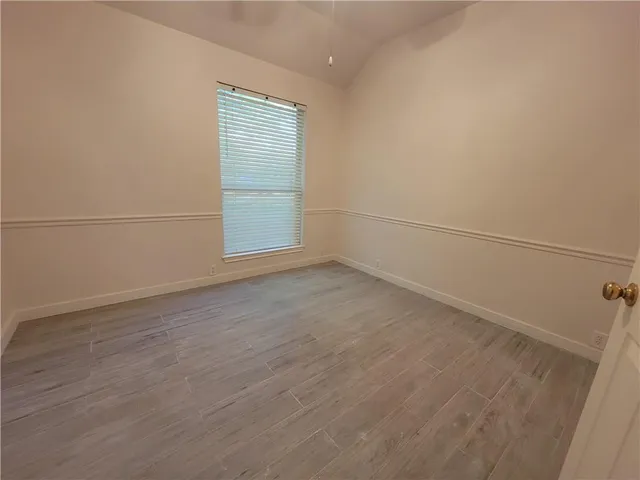 an empty room with a empty space and windows