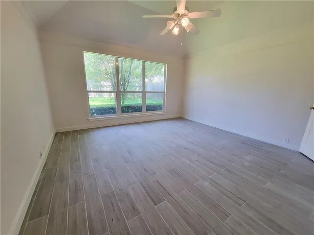 wooden floor in an empty room with a window