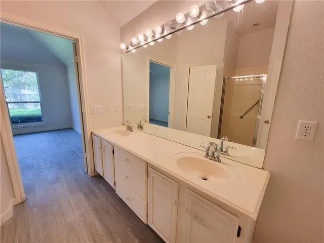 a spacious bathroom with a double vanity sink and mirror
