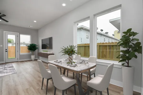 a view of a dining room with furniture window and wooden floor