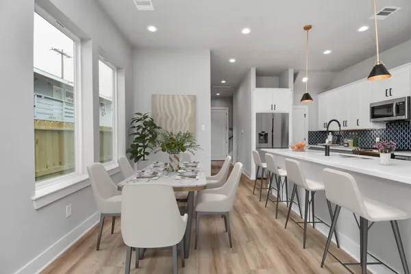 a view of a dining room with furniture window and wooden floor