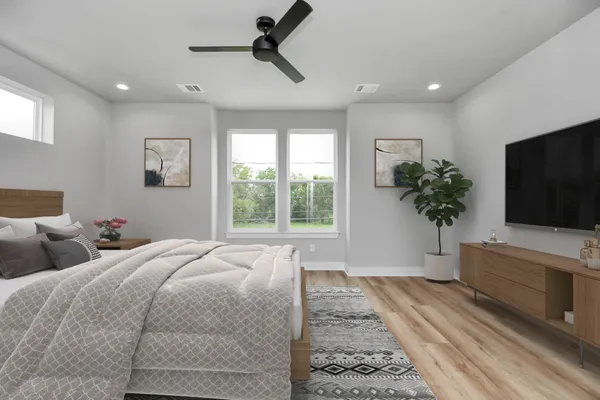 a bedroom with a bed and a flat screen tv