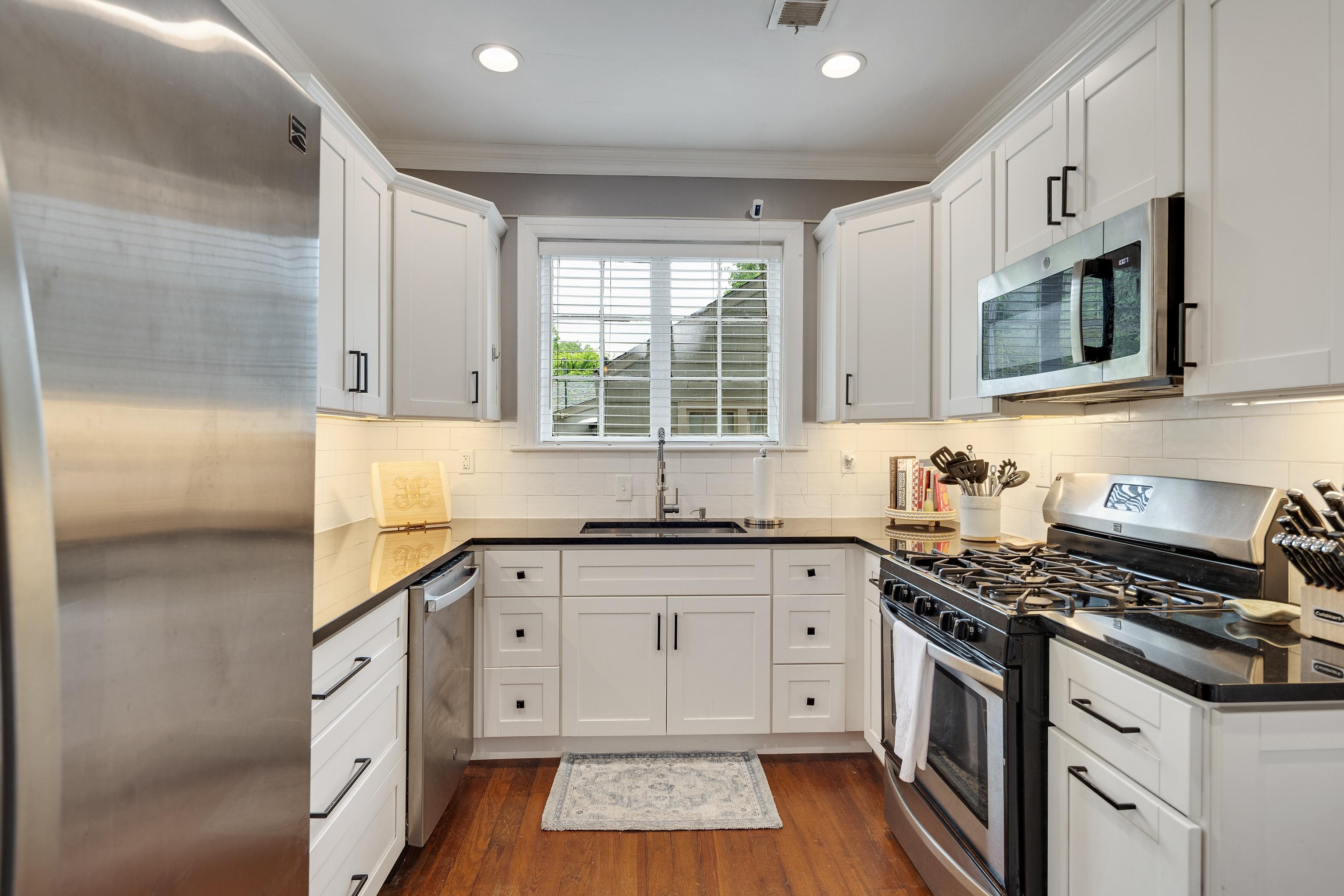 555 South Holmes Street Memphis, TN 38111 - Photo 11 of 40 a kitchen with stainless steel appliances granite countertop a stove a sink and a microwave