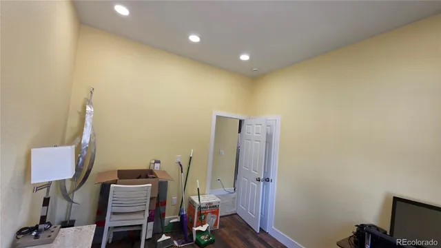a view of a workspace with furniture and wooden floor