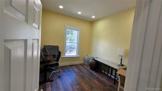 a view of a hallway with workspace and a window