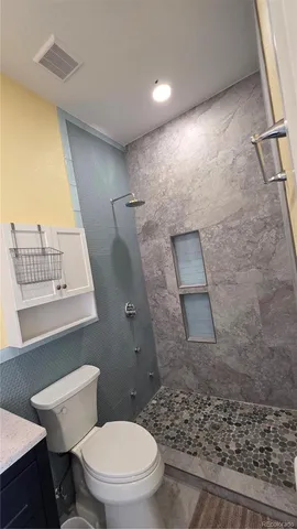 a bathroom with a toilet and a shower