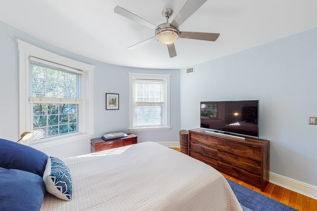 94 University Road, Unit 4 Brookline, MA 02446 - Photo 10 of 27 a bedroom with a bed and a flat screen tv