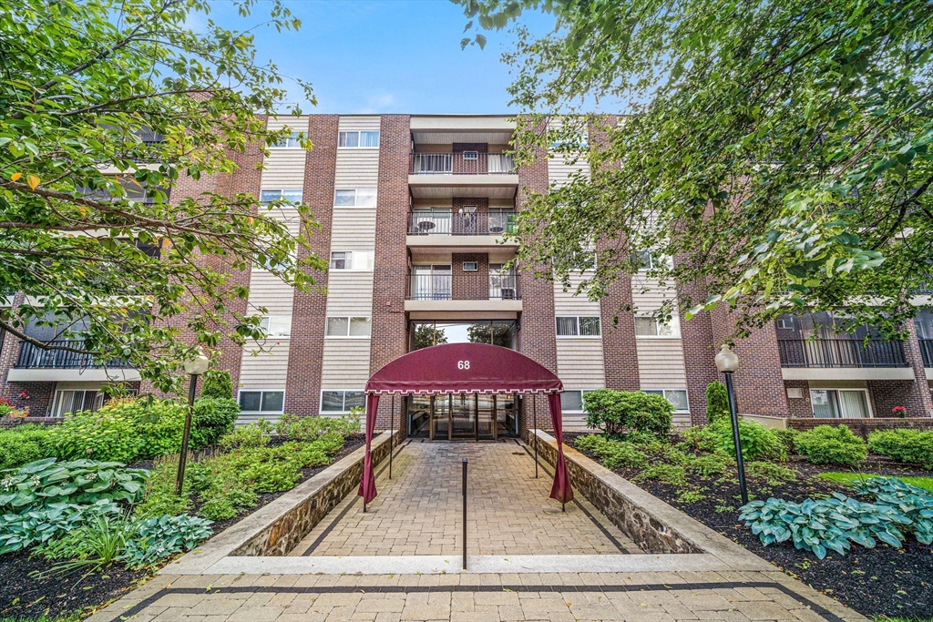 68 Main Street, Unit 17C Stoneham, MA 02180 - Photo 13 of 13 a view of a brick building with a yard