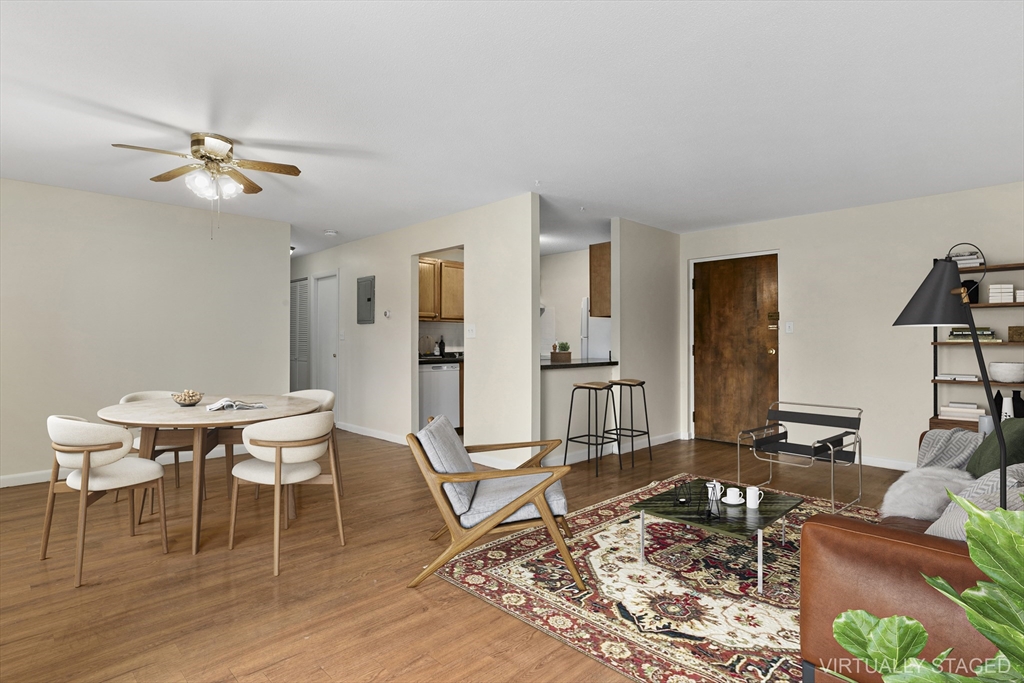 68 Main Street, Unit 17C Stoneham, MA 02180 - Photo 2 of 13 a living room with furniture a rug and white walls