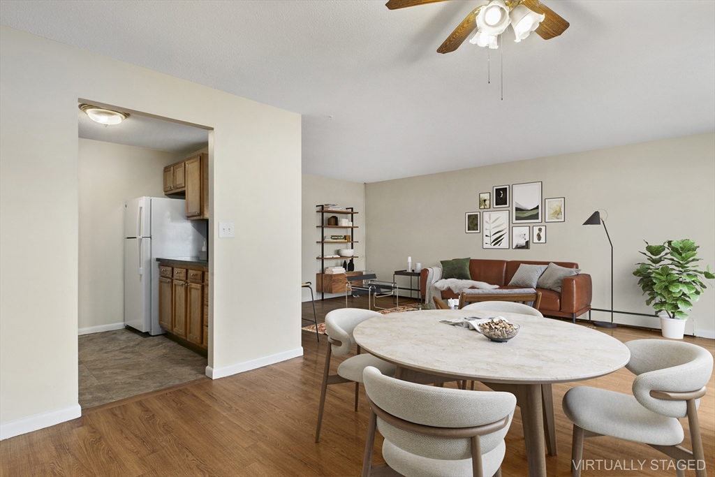 68 Main Street, Unit 17C Stoneham, MA 02180 - Photo 3 of 13 a view of a dining room with furniture and wooden floor