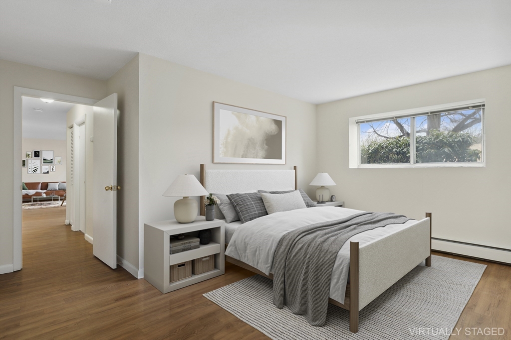 68 Main Street, Unit 17C Stoneham, MA 02180 - Photo 6 of 13 a bedroom with a bed and a painting on the wall