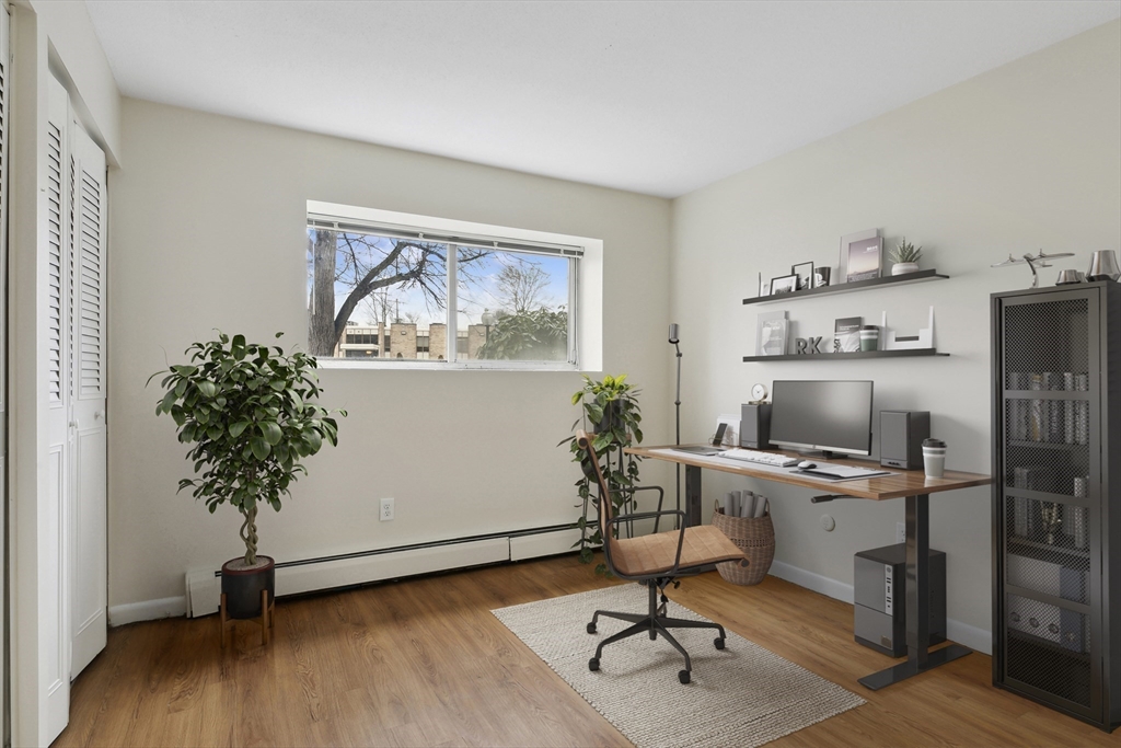68 Main Street, Unit 17C Stoneham, MA 02180 - Photo 9 of 13 a workspace with furniture and wooden floor